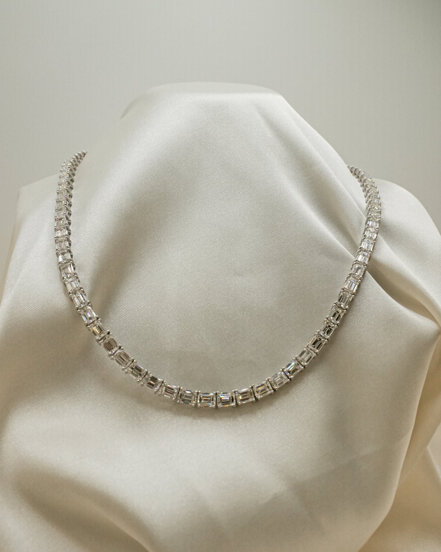 Diamond necklace on a white fabric background