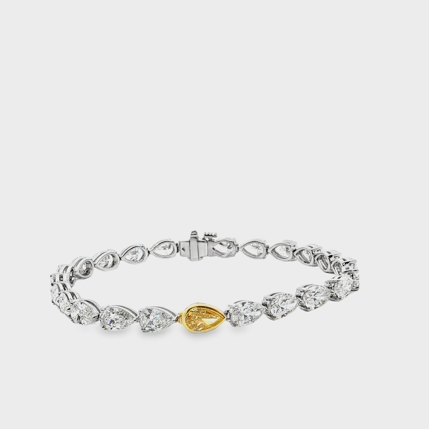 18k-white-gold-tennis-bracelet-with-pear-cut-fancy-vivid-yellow-diamond