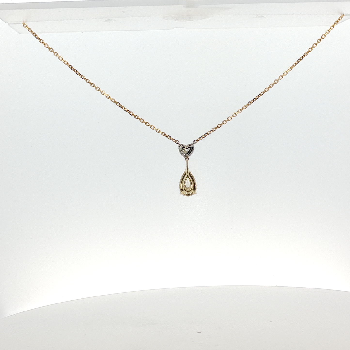 yellow-gold-necklace-with-heart-shape-and-pear-cut-diamond-pendant