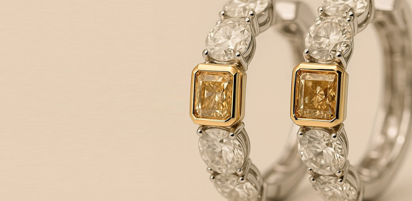 Close-up of a diamond earrings with yellow and white stones on a beige background