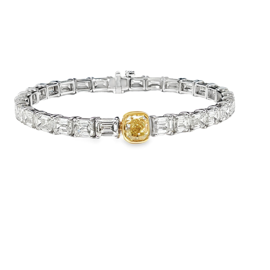 18K White Gold Tennis Bracelet with 29 Emerald Cut Diamonds and a GIA 1.50 Fancy intense Yellow Diamond