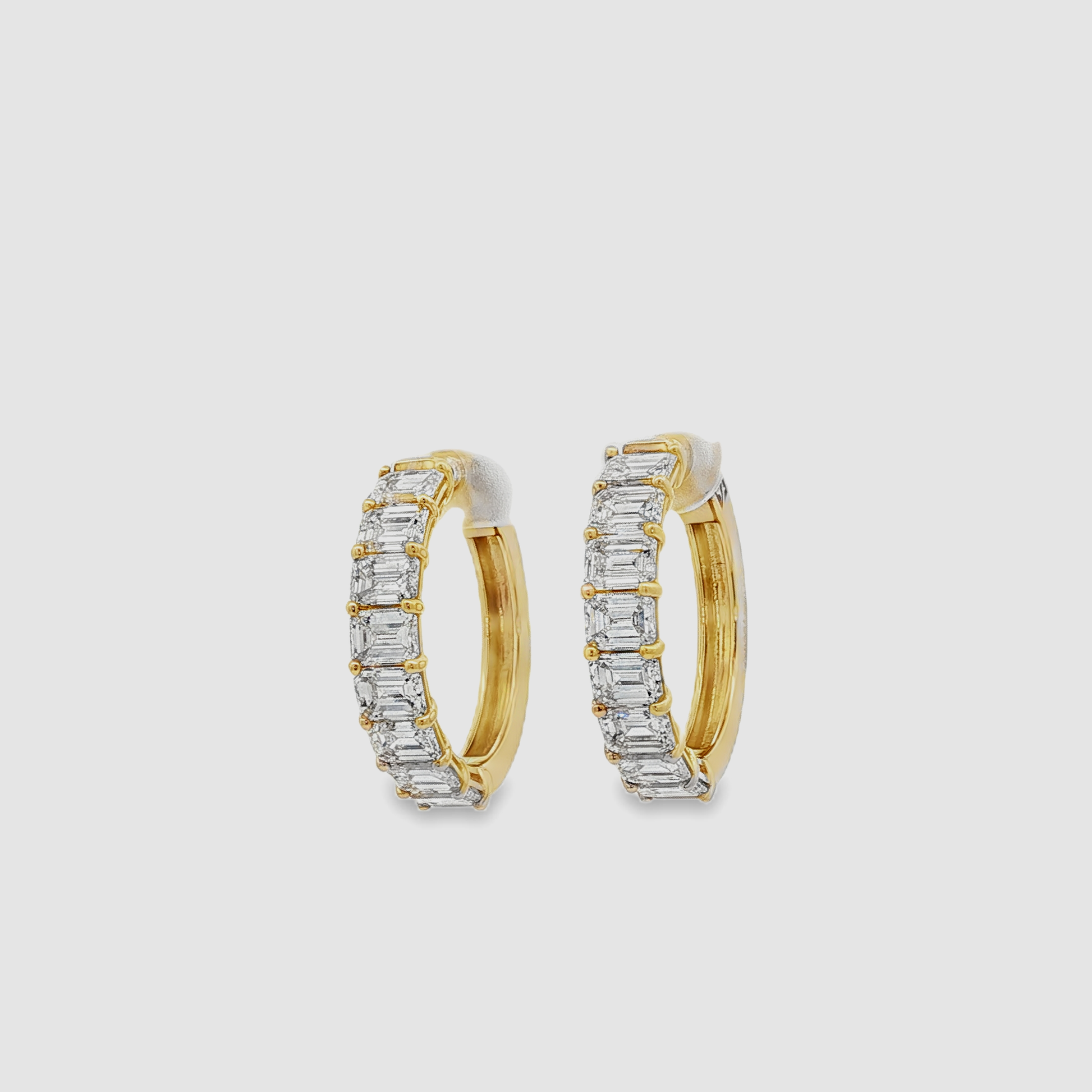 14K Yellow gold hoops with 6.87 CT Emerald Cut Diamonds