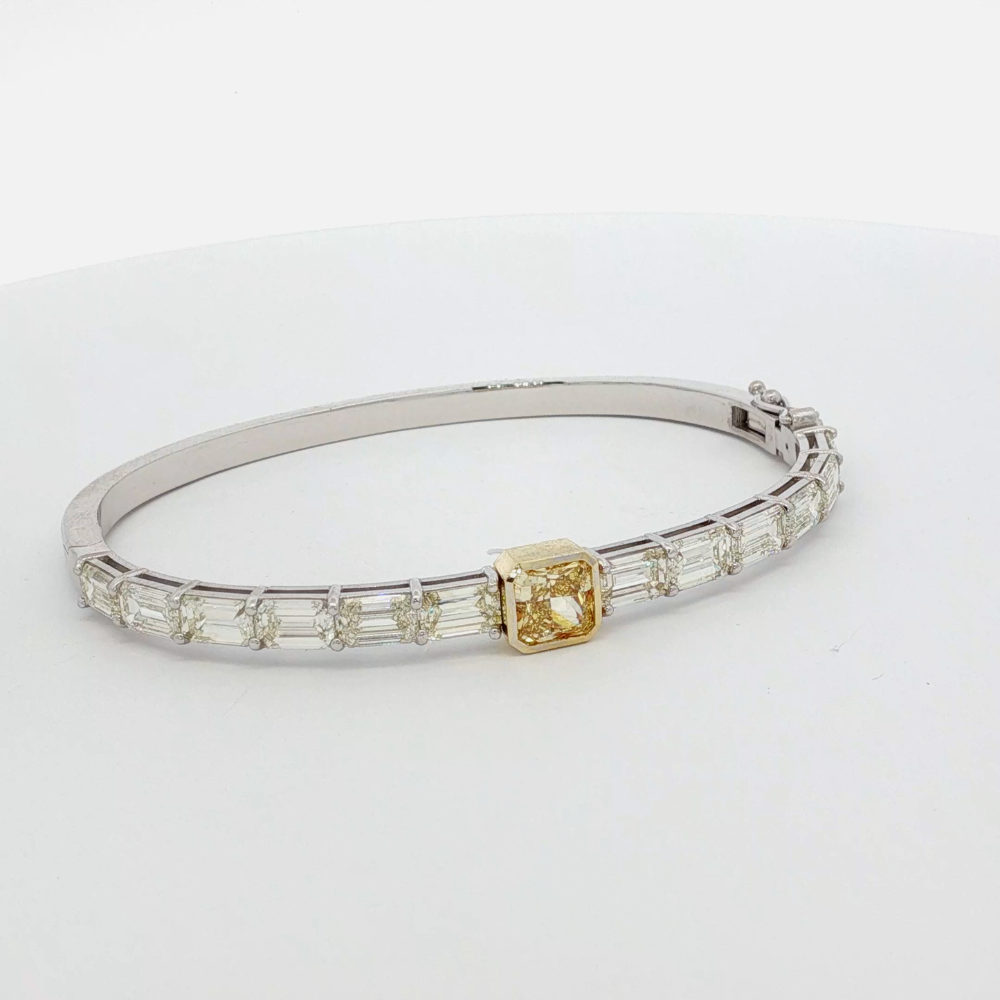 14k-white-gold-bangle-featuring-a-1-53-fancy-intense-yellow-gia-yellow-radiant-cut-diamond