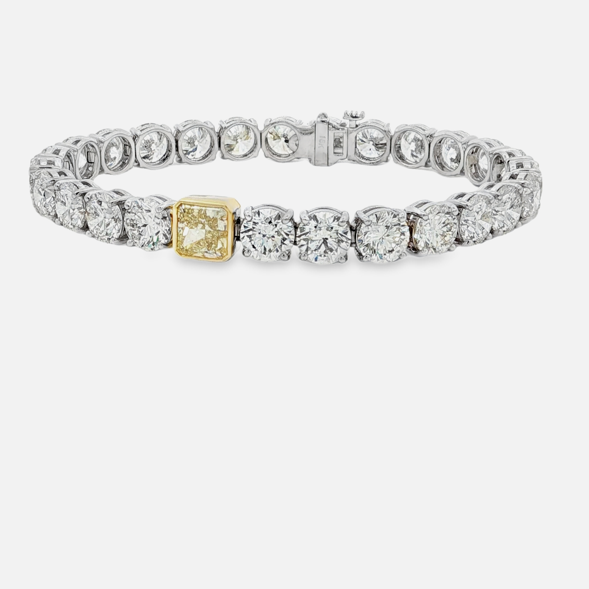 18kwg-tennis-bracelet-with-26ct-brilliant-cut-diamonds-and-a-1-72-fancy-yellow-diamond