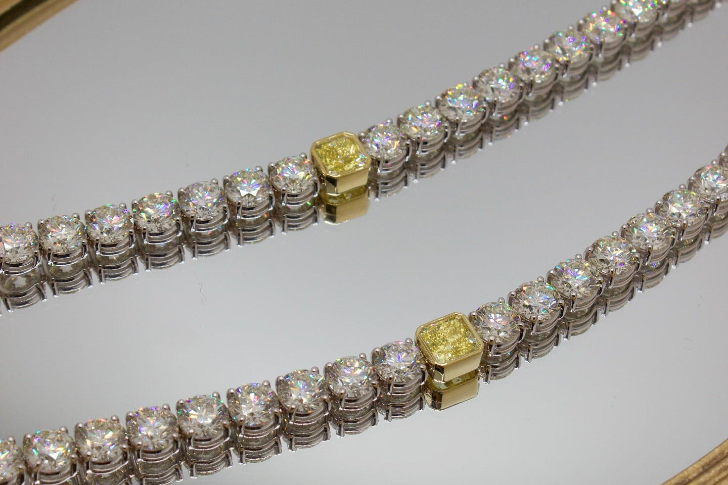 Diamond bracelet with yellow and white diamonds on a light gray background